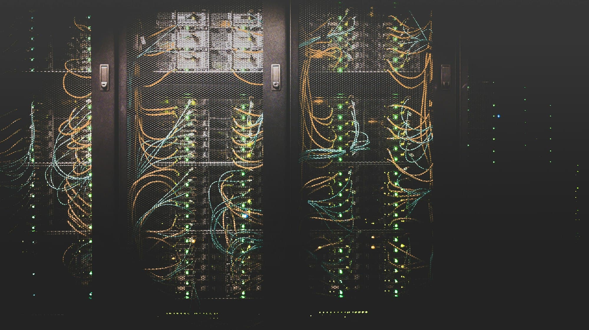 Server racks with structured cabling and status LEDs in a data center