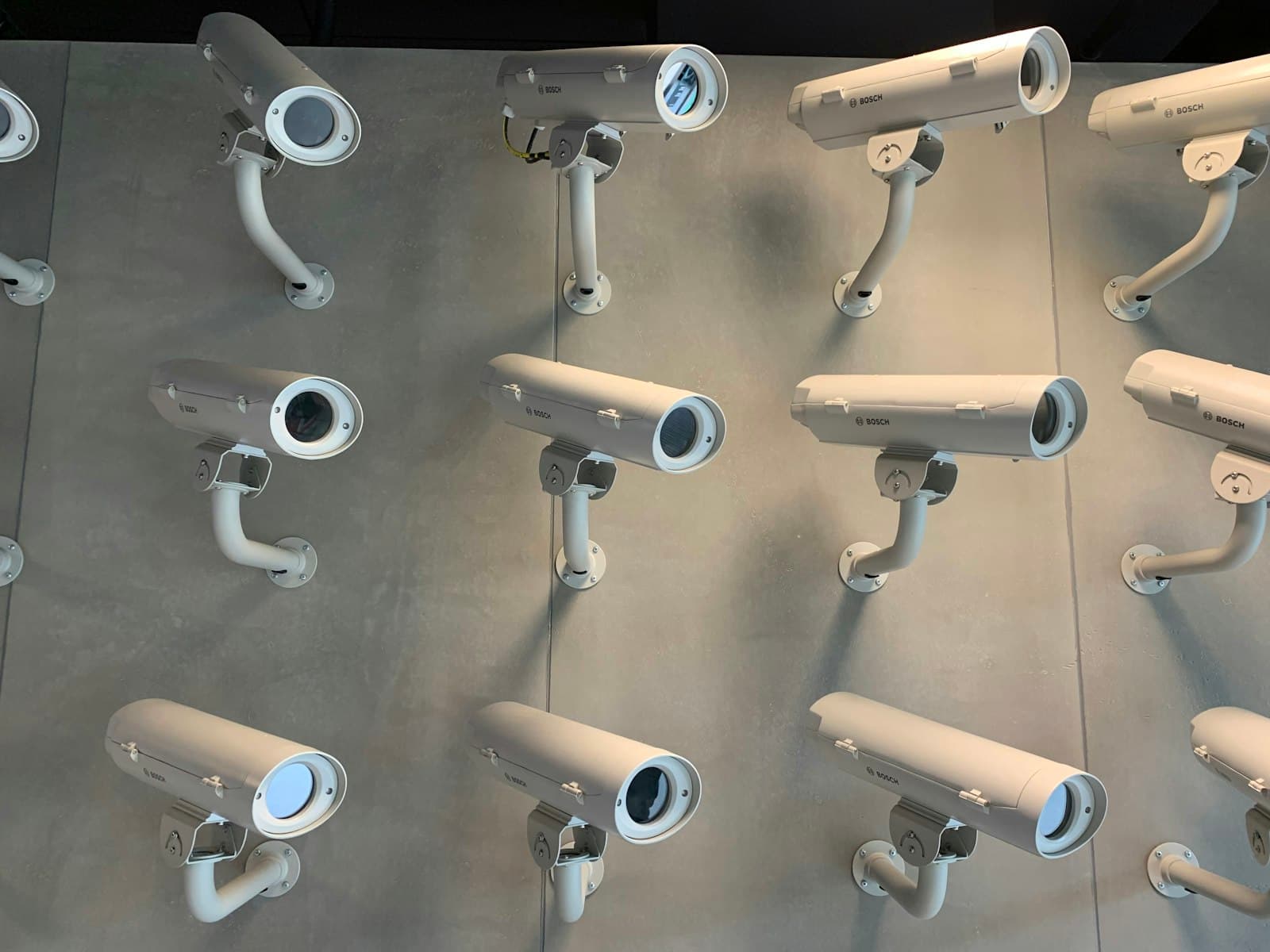 Wall of mounted CCTV surveillance cameras