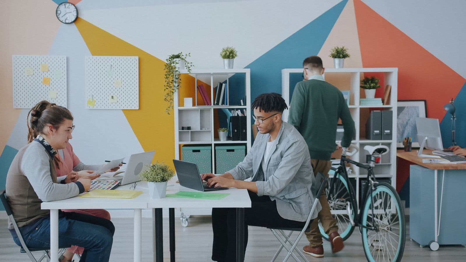 Candid view of teams in motion on a bright, colorful office floor